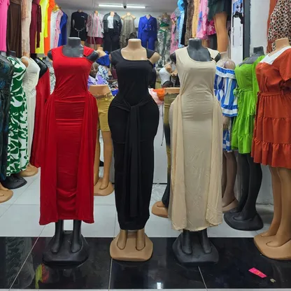 Classy dinner dresses in red, black and beige on mannequins